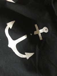 a black t - shirt with an anchor on it
